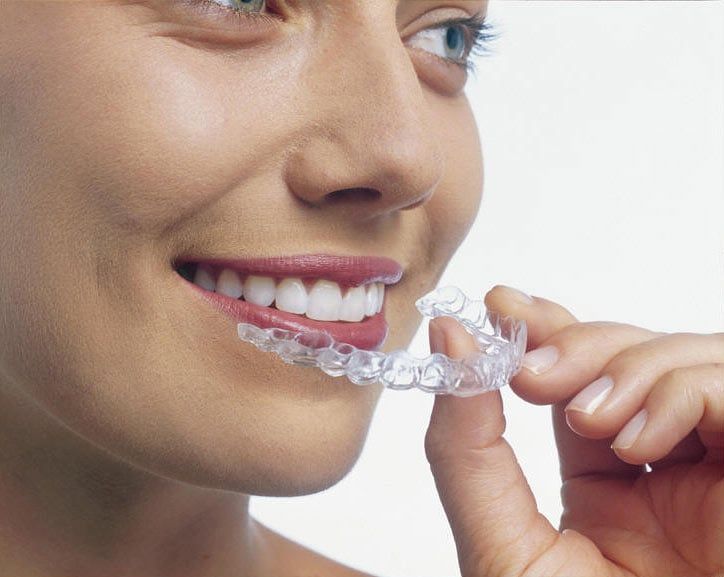 woman holding invisalign